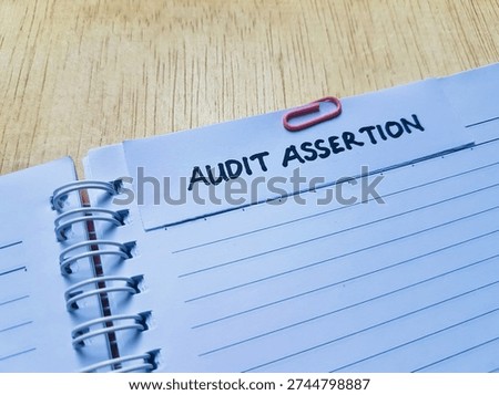 Audit assertion writting on table background. 