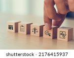 Audit business concept. Examination and evaluation of the financial statements of an organization; income statement, balance sheet, cash flow statement.  Holding wooden cubes with audit icon.