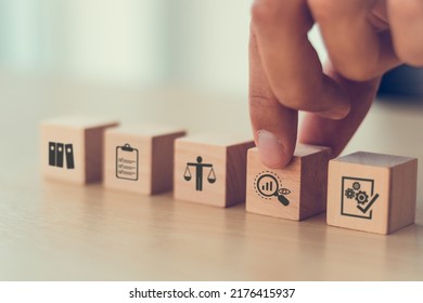 Audit business concept. Examination and evaluation of the financial statements of an organization; income statement, balance sheet, cash flow statement.  Holding wooden cubes with audit icon. - Shutterstock ID 2176415937