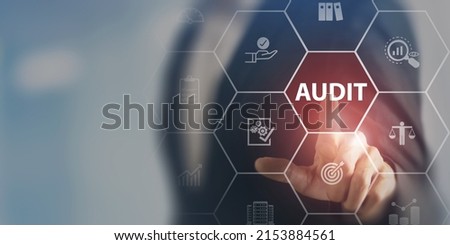 Audit business concept. Examination and evaluation of the financial statement of an organization; income statement, balance sheet, cash flow statement. Businessman touching on audit, smart background.