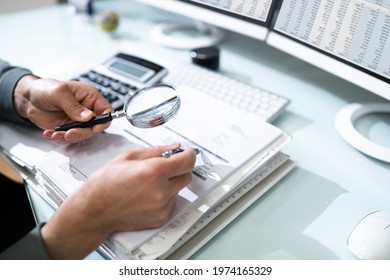 Audit And Fraud Investigation. Auditor Using Magnifying Glass On Document - Shutterstock ID 1974165329