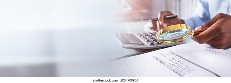 Audit And Fraud Investigation. Auditor Using Magnifying Glass On Document - Shutterstock ID 2054709956