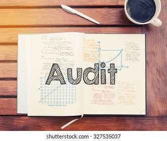 Audit : text inside notebook on table with coffee