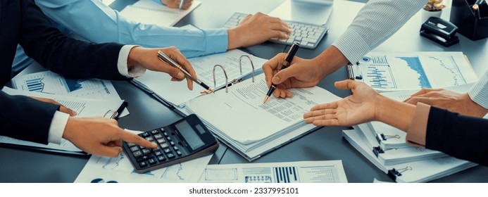Auditor and accountant team working in office, analyze financial data and accounting record with calculator. Accounting company provide finance and taxation planning for profitable cash flow. Insight - Shutterstock ID 2337995101