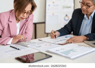 Auditor and accountant team working in office, analyze financial data and accounting record with calculator. Accounting company provide finance and taxation planning for profitable cash flow. Insight