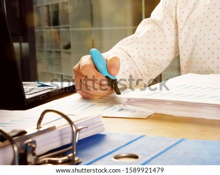 Auditor is checking the papers and making internal audit