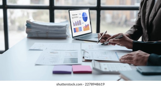 Auditor and the company's bookkeeper jointly review the balance sheet and assets, liabilities and equity information in the quarterly report, bookkeeping concept.