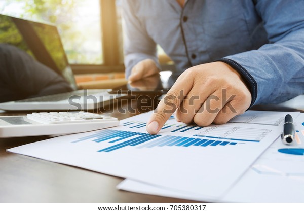 auditor or financial inspector working
on sales performance report at modern
workplace