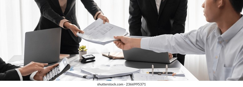 Auditor team collaborate in office, analyzing financial data and accounting record. Expertise in finance and taxation with accurate report and planning for company revenue, expense and budget. Insight - Shutterstock ID 2366995371