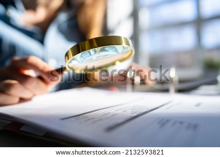 Auditor Using Magnifying Glass For Audit And Fraud Investigation