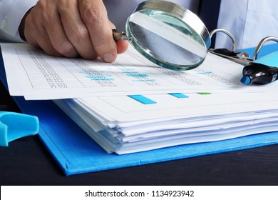 Auditor is working with financial documents. Audit or assessments.
