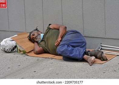  Aug. 14, 2020: Black Homeless Man With No Shoes And Swollen Feet Sleep On Cardboard In The Street In Mid-town Manhattan New York City.