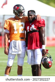 Aug 18, 2021; Tampa, FL USA;  Tampa Bay Buccaneers quarterback Tom Brady (12) and wide receiver Chris Godwin (14) share a moment and talk during NFL training camp.