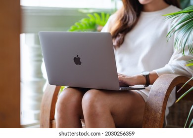 Aug 7th 2021 : A Woman Using And Working On Apple MacBook Pro Laptop Computer At Home, Chiang Mai Thailand