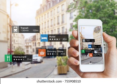 Augmented Reality (AR) information technology about nearby businesses and services on smartphone screen guide customer or tourist in the city, close-up of hand holding mobile phone, blurred street - Shutterstock ID 755908510