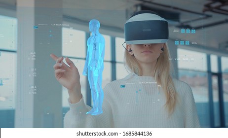 Augmented Reality. Close-up of a Female Doctor Looking: Medical Charts, 3D Hologram (DNA hologram, Pulmonary System, Muscular System, COVID-19) Wearing VR Glasses and Headsets. Future Medicine. VR