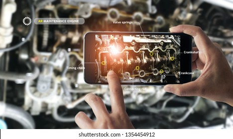 Augmented Reality Concept. AR. Industrial 4.0 , Hand Of Engineer Holding Mobile Smart Phone Using Virtual AR To Check The Work Of Electric Machine On Smart Factory Background.