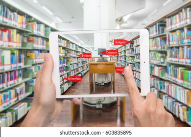 Augmented reality education concept. Hand holding digital tablet smart phone use AR application to check library category in bookshelf at university library.