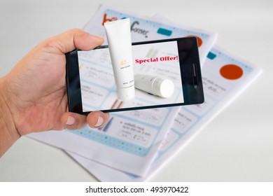 Augmented Reality Marketing Concept. Hand Holding Smart Phone To Use A/R Application To Product Details Form A/R Catalog.