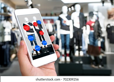 Augmented Reality Marketing Concept. Hand Holding Smart Phone Use AR Application To Check Number Of Social Media Like And Sale Price In Retail Fashion Shop