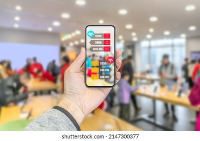 Augmented Reality Marketing In The Shopping Mall. Hand Holding Smart Phone Use AR Application To Check Electronic Product Information