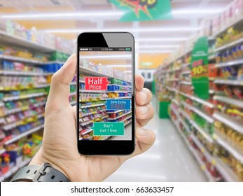 Augmented Reality For Smart Retail Business Concept.hands Holding Mobile Phone On Blurred Supermarket As Background