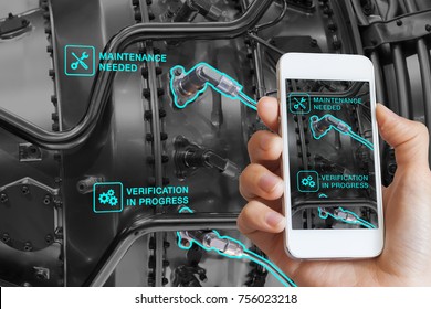 Augmented Reality technology maintenance and service of mechanical parts, technician using smartphone with AR interface on screen in smart industry, automated monitoring process - Shutterstock ID 756023218
