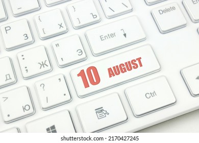 August 10th. Day 10 of month, Calendar date. Cropped view of Modern White Computer Keyboard with calendar date. Concept workspace, freelance, deadline.  Summer month, day of the year concept