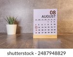 August 11th. August 11 wooden cube calendar with blur objects on background.