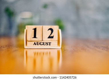August 12th. Soft Selective focus on wooden block calendar on blurred wooden table and loft cement background with copy empty space for text. 12 august in every year is mother’s day in Thailand. - Shutterstock ID 1142405726