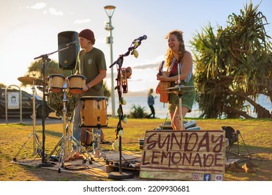 August 14, 2022: Byron Bay, New South Wales, Australia - Man And Woman Busking Outdoors In Sunny Weather