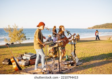 August 14, 2022: Byron Bay, New South Wales, Australia - Man And Woman Busking Outdoors In Sunny Weather