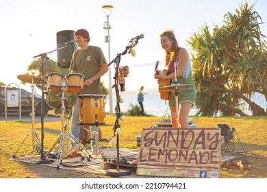 August 14, 2022: Byron Bay, New South Wales, Australia - Man And Woman Busking Outdoors In Sunny Weather