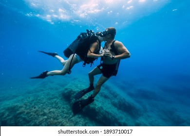 August 20, 2020. Anapa, Russia. Couple Of Scuba Divers Kiss Underwater In Transparent Blue Sea. Scuba Diving In Ocean