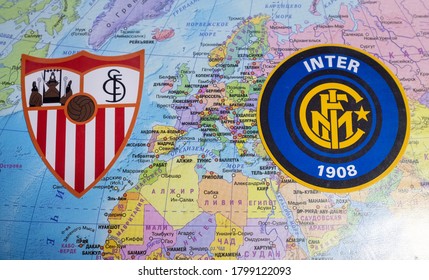 August 20, 2020 Cologne, Germany. The Emblems Of The 2019/2020 Europa League Finalists Sevilla FC And Inter Milan Against The Background Of The Europe Map.