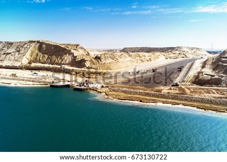 In August 2015 newly opened Eastern Expansion Canal of the Suez Canal with a view of the excavated sand masses and an access road to a ferry dock