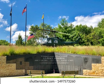 August 2019 Rockford, IL. LZ Peace Memorial At Midway Village. A Helicopter And Memorial Name Wall Honoring Winnebago County Veterans Of All Branches Of The Armed Forces.