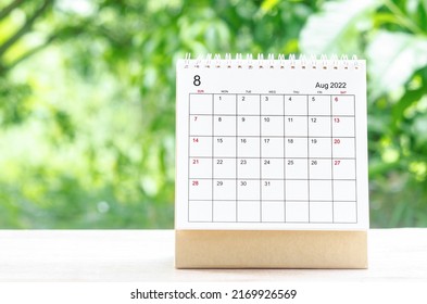 The August 2022 Calendar Desk For Organizer To Plan And Reminder On Wooden Table On Nature Background.