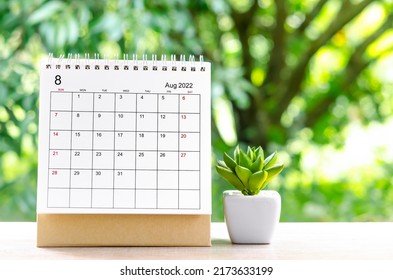 The August 2022 Calendar Desk For Organizer To Plan And Reminder On Wooden Table On Nature Background.