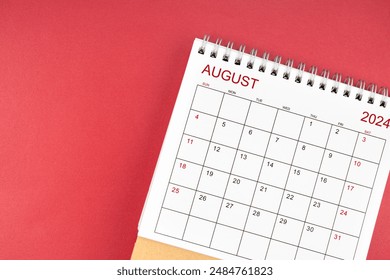 The August 2024 desk calendar on red color background.