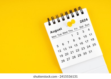 August 2024 Monthly desk calendar for 2024 year with thumbtack on yellow background.