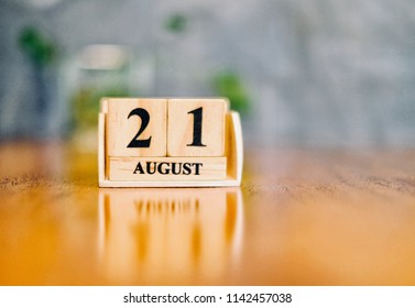 August 21th. Soft Selective focus on wooden block calendar on blurred wooden table and loft cement background with copy empty space for text. - Shutterstock ID 1142457038