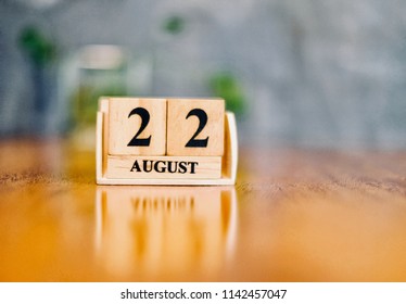 August 22th. Soft Selective focus on wooden block calendar on blurred wooden table and loft cement background with copy empty space for text. - Shutterstock ID 1142457047