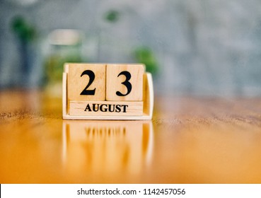 August 23th. Soft Selective focus on wooden block calendar on blurred wooden table and loft cement background with copy empty space for text. - Shutterstock ID 1142457056
