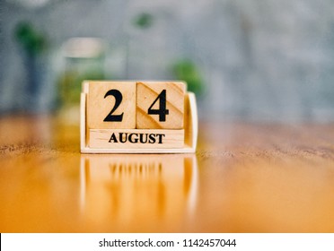 August 24th. Soft Selective focus on wooden block calendar on blurred wooden table and loft cement background with copy empty space for text. - Shutterstock ID 1142457044