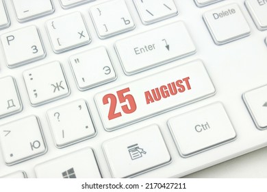 August 25th. Day 25 of month, Calendar date. Cropped view of Modern White Computer Keyboard with calendar date. Concept workspace, freelance, deadline.  Summer month, day of the year concept