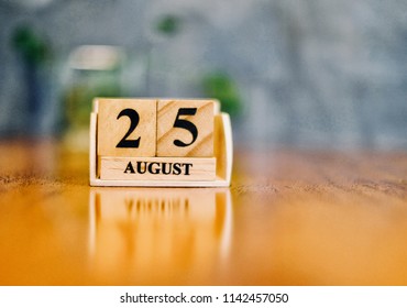 August 25th. Soft Selective focus on wooden block calendar on blurred wooden table and loft cement background with copy empty space for text. - Shutterstock ID 1142457050