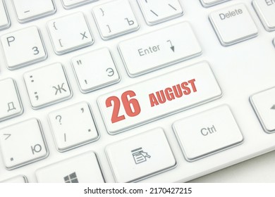 August 26th. Day 26 of month, Calendar date. Cropped view of Modern White Computer Keyboard with calendar date. Concept workspace, freelance, deadline.  Summer month, day of the year concept