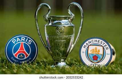 August 27, 2021 Paris, France. The emblems of the football clubs Paris Saint-Germain F.C. and Manchester City F.C. and the UEFA Champions League Cup on the green turf of the stadium.