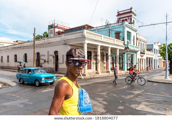 August 28, 2019:\
Man smoking with American flag cap and glasses on the streets of\
Cienfuegos. Cienfuegos,\
Cuba